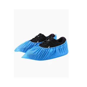 Blue shoe covers on black shoes against a white background